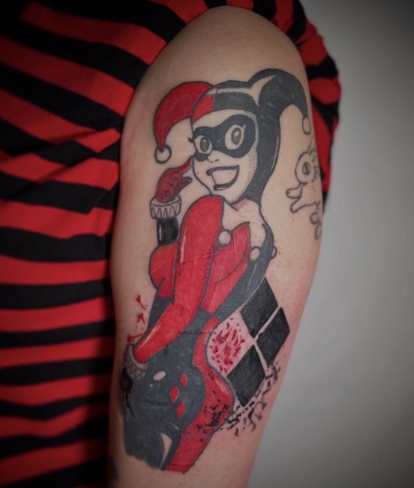 Harley Quinn portrait tattoo by LoLo, on the upper arm