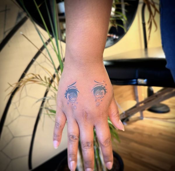 Anime eye flash tattoo by LoLo, on the hand